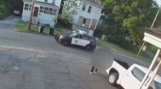 Watch: Man carries dead body on his back the exact moment a police cruiser drives by