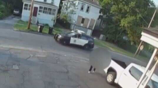 Watch: Man carries dead body on his back the exact moment a police cruiser drives by