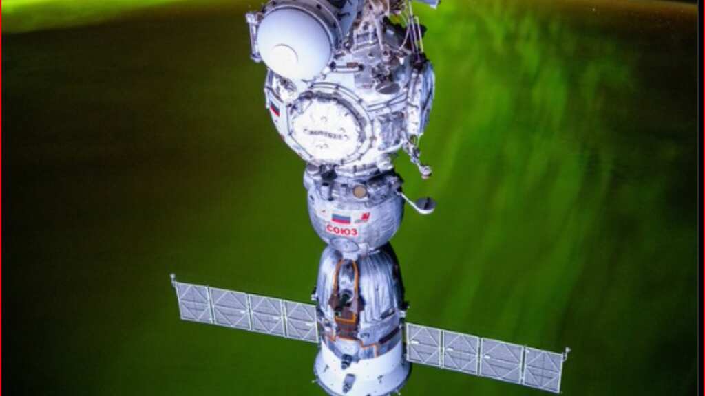 PHOTO: Green aurora dances behind Russian spacecraft docked at ISS