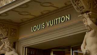 Louis Vuitton staff counts $84,050 in cash given by a buyer. She then walks out