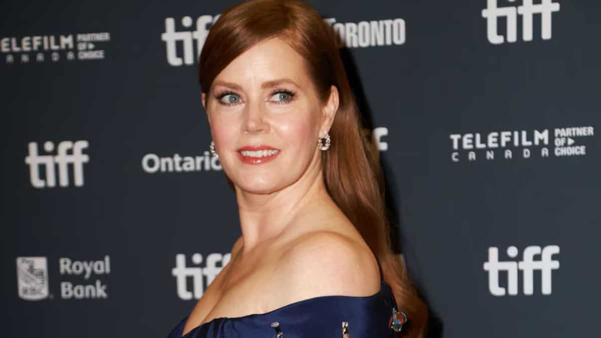 Amy Adams walks the TIFF red carpet after her run with the dogs in 'Nightbitch'