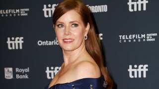 Amy Adams walks the TIFF red carpet after her run with the dogs in 'Nightbitch'