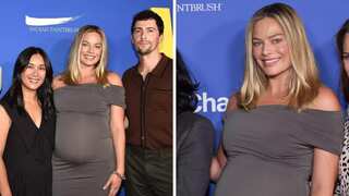 Pregnant Margot Robbie beams with joy as she makes first red carpet appearance with baby bump