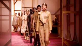 Tan leather and trio of protesters parade Hermes catwalk in Paris