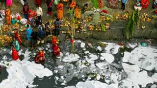 Woman seen applying toxic foam to her hair while bathing in Yamuna river