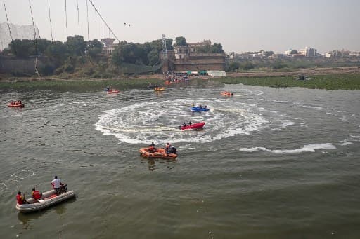 Morbi bridge collapse: Rescue workers conduct search operations. 