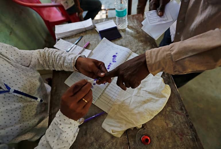 A man gets his finger inked before casting his vote at a polling station in Majuli, a large river island in the Brahmaputra river, in the northeastern Indian state of Assam, April 11, 2019