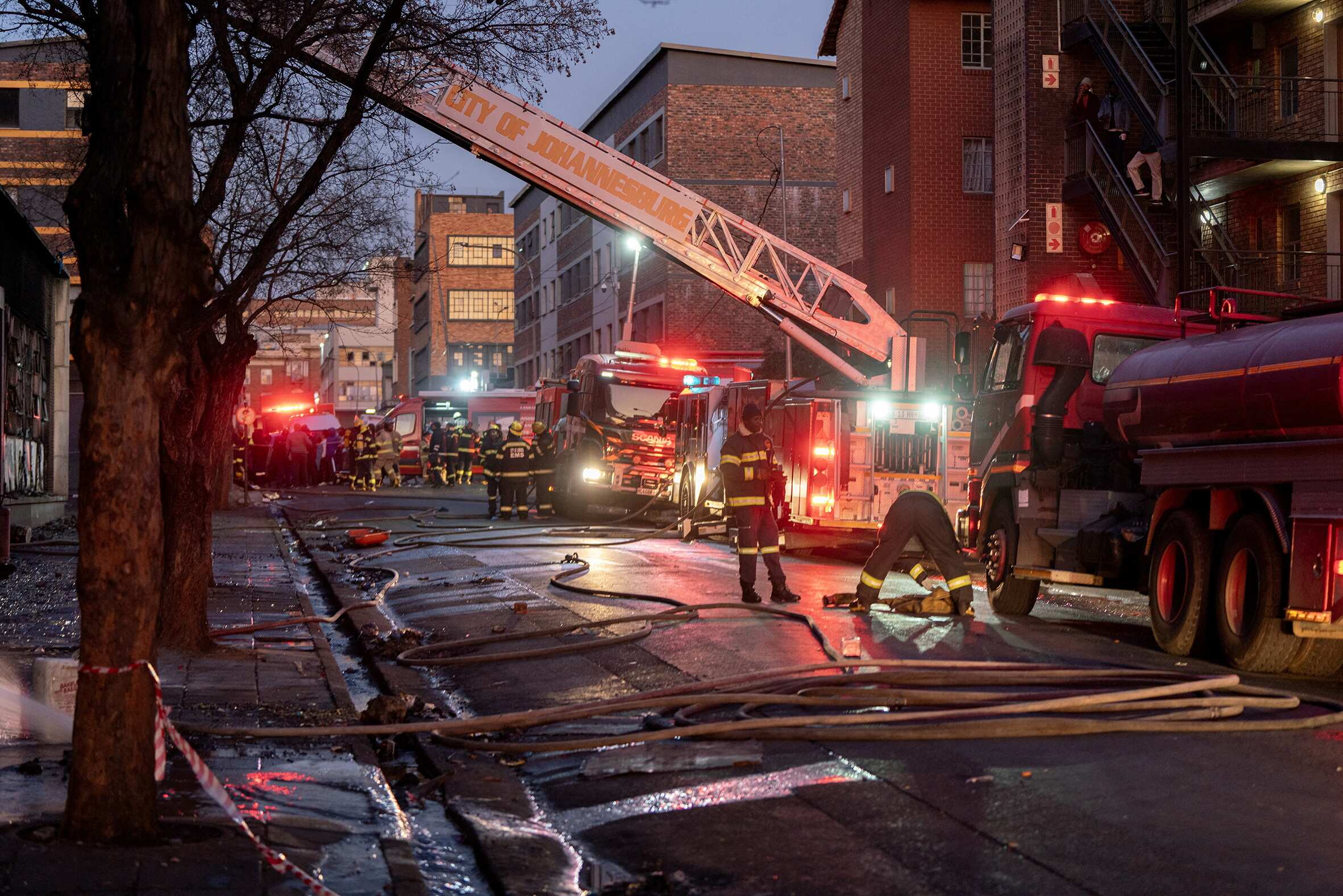 Firefighters work at the scene of a deadly blaze in Johannesburg.