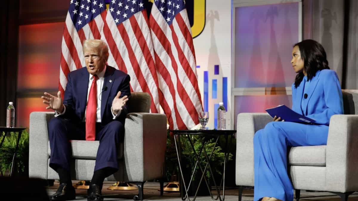Former US President and 2024 Republican presidential nominee Donald Trump answers questions as moderator and journalist Rachel Scott (R) looks on during the National Association of Black Journalists annual convention in Chicago, Illinois, on July 31, 2024.