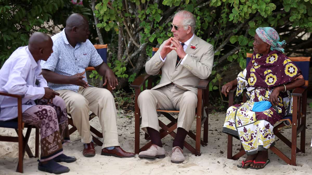 Britain's King Charles sits on the beach with community elders during a visit to the Kuruwitu Marine Conservation Reserve as part of his state visit to Kenya