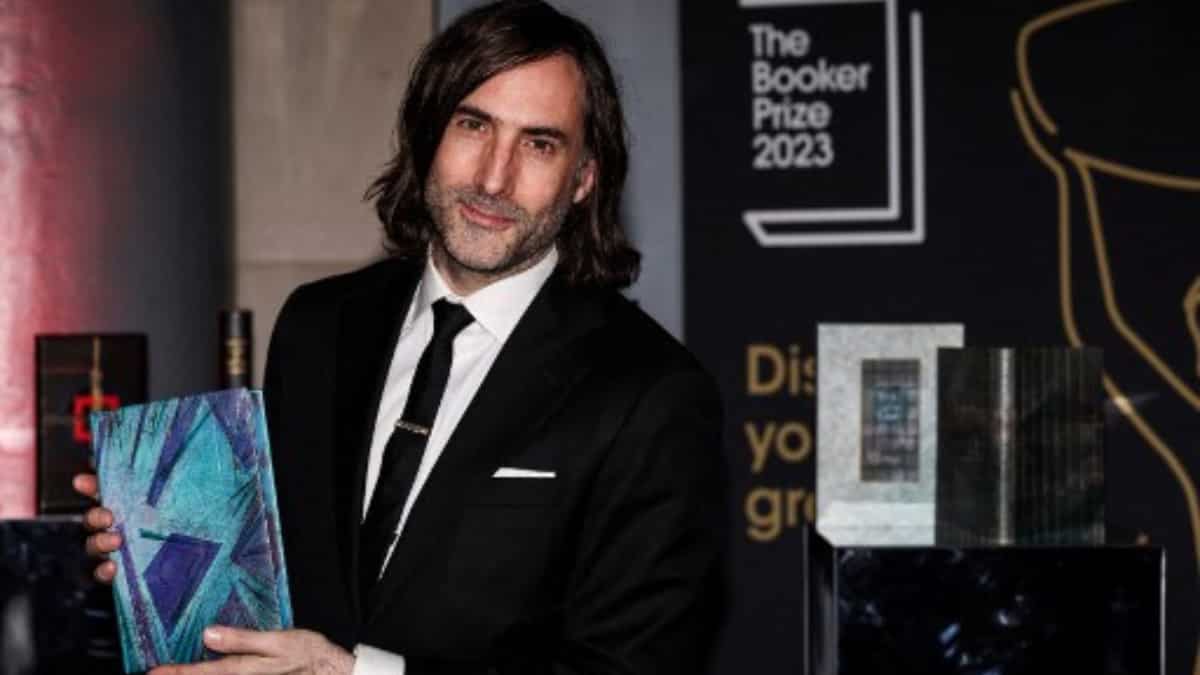 Irish writer Paul Lynch with his specially bound book copy 'Prophet Song' on the red carpet of Booker Prize Award announcement ceremony, at the Old Billingsgate, in central London, on November 26, 2023 | AFP