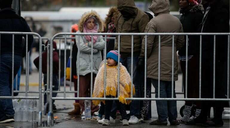 Migrants, who are part of a group who arrived in the previous days after crossing part of the Aegean Sea from Turkey to Greece, wait for an identification process before being transported to the mainland on a Greek Navy vessel from the port of Mytilene, on the island of Lesbos, Greece