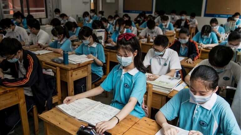 Students wear face masks as they study in a classroom in a high school in Wuhan in China
