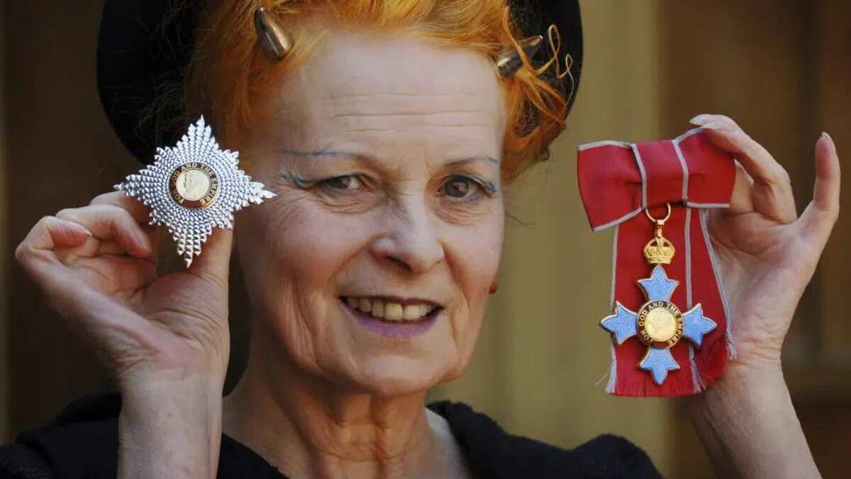 poses for a photo after collecting her insignia from Britain's Prince Charles during an Investiture ceremony at Buckingham Palace