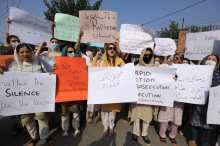 People carry signs against gang rape in Pakistan