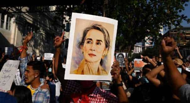 A protester holds a portrait of Aung San Suu Kyi during a demonstration against the military coup in Yangon 