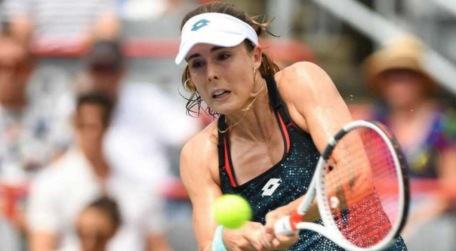 Alize penalised for taking her shirt off during US Open match