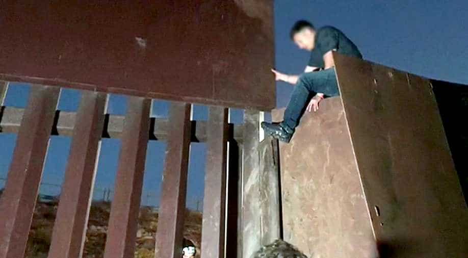 Watch Migrants jump USMexico border fence at night, World News