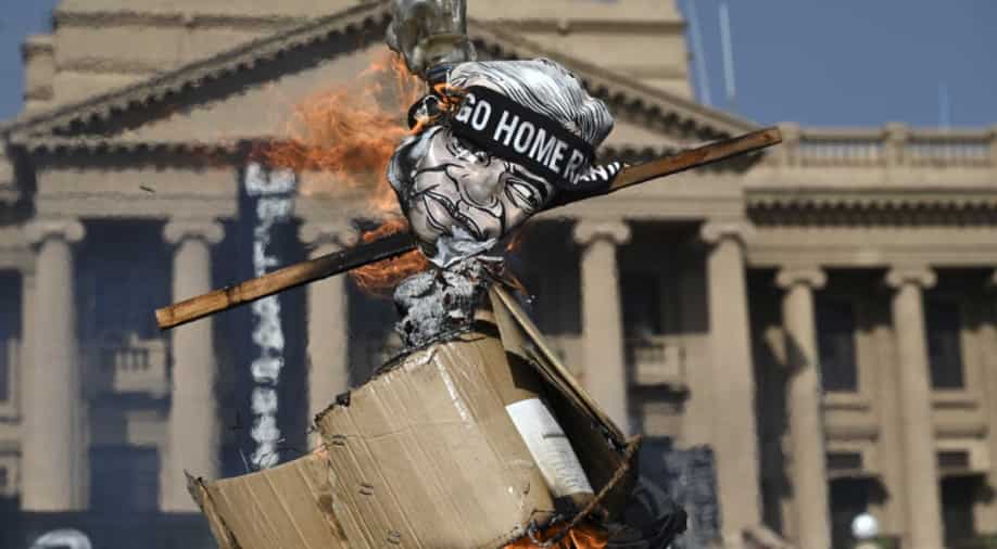 As it happened: Demonstrators burn an effigy of interim Sri Lankan President Wickremesinghe