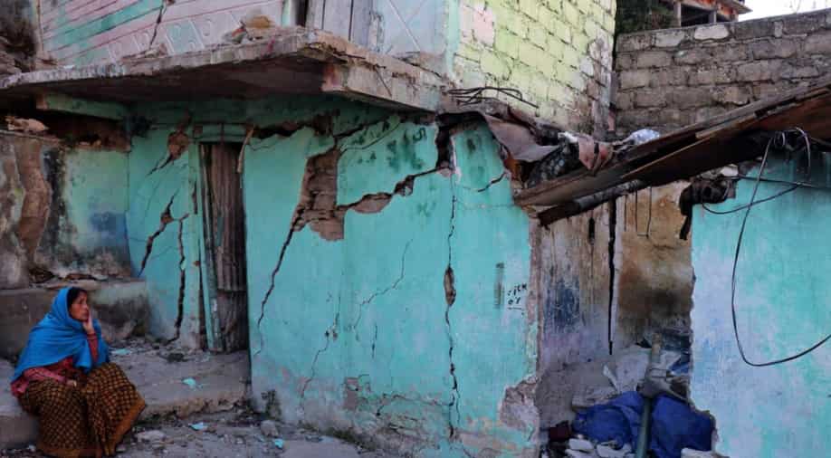 Joshimath: Bulldozers prepare to raze buildings leaving people in tears